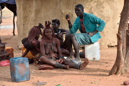 KAMANJAB, NAMIBIA - FEB 1, 2016: Unidentified Himba women with the typical necklace and hairstyle,...