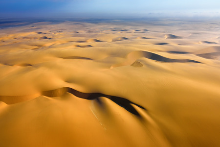 Aerial view on the beautiful landscape of the Namib Desert at sunset. Flying on a small plane over the desert is one of the most popular tourist attractions in Namibiaの写真素材