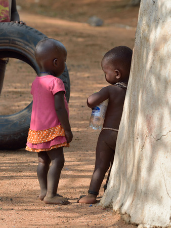 KAMANJAB, NAMIBIA - FEB 1, 2016: Little unidentified Himba children shown in himba tribe village