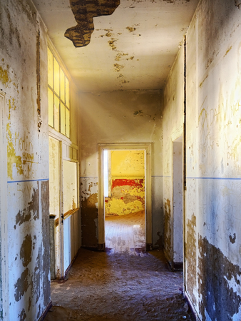 The abandoned ghost diamond town of Kolmanskop in Namibia, which is slowly being swallowed by the desertの写真素材