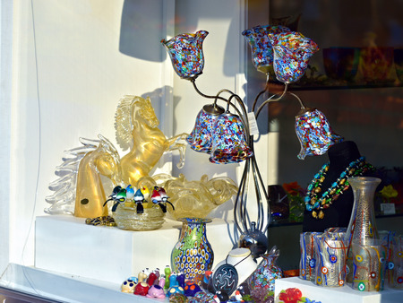 MURANO, ITALY - SEP 25, 2014: Glass goods from murano glasses displayed in a shop window. Today, Murano is home to a vast number of factories making all manner of glass objectsのeditorial素材