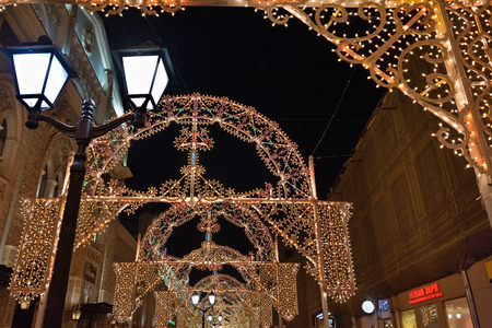 MOSCOW, RUSSIA - JAN 05, 2016: Moscow christmas decoration. Vintage street lamp Light arched gallery on Nikolskaya Street during annual festival Christmas lightのeditorial素材