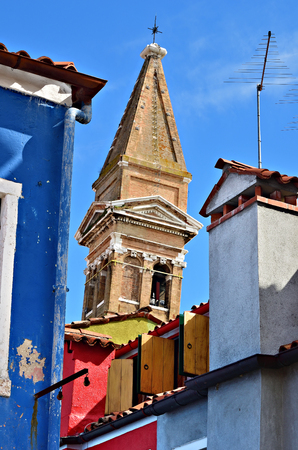 Roofs of the building and bell tower on background in Burano island, Venice. Colorful houses island and landmark of Veneto region, Italyの写真素材