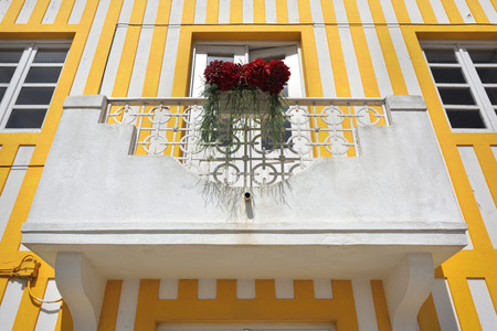 Balcony with flowers of the house in famous resort Costa Nova on the Atlantic coast in Beira Litoral, Portugal. Popular tourist destination to spend vacation timeの写真素材