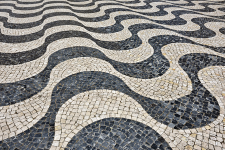 Medieval cobbled square in wave design, Portugal.の写真素材