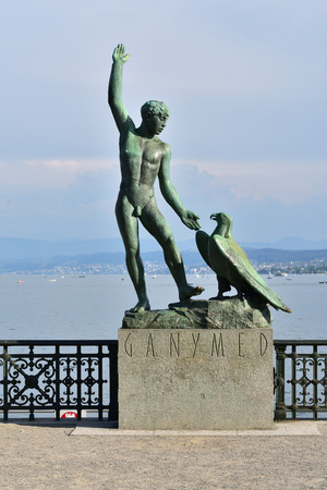 Zurich Switzerland - June 14, 2017: Ganymed Statue (statue of a man and a eagle) in Zurich Switzerland - Lake Zurich panorama in the backgroundのeditorial素材