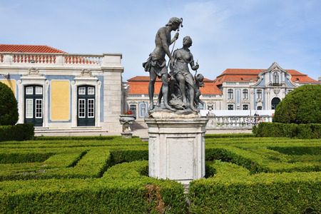 Queluz, Portugal - June 3, 2017: Neptune gardens, sculpture Meleager and Atlanta  by sculptor John Cheere  and the facades of the Queluz Royal Palaceのeditorial素材