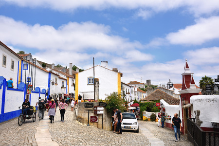 Obidos, Portugal - June 1, 2017: Charming medieval street of the old town Obidos in Portugal. Obidos is popular tourist destinationのeditorial素材