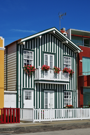 Costa Nova, Aveiro. Green striped house in the famous resort on the Atlantic coast, Portugal. Popular tourist destination to spend vacation timeのeditorial素材