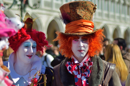 Venice, Italy - March 6, 2011: Unidentified  participants in costumes Queen of Hearts and Mad Hatter from Alice in Wonderland story on St. Mark's Square during the Carnival of Veniceのeditorial素材
