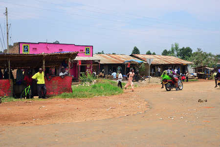 Uganda - August 30, 2010: Road scene in central Uganda. Nearly 40% of local dwellers have a monthly income of just 2500 shillings less than a dollarのeditorial素材