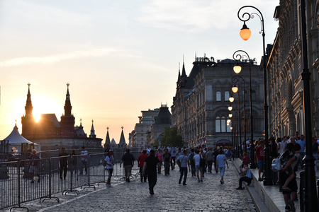 Moscow, Russia - June 23, 2018: Tourists  on the Red Square, the building of the Main Universal...