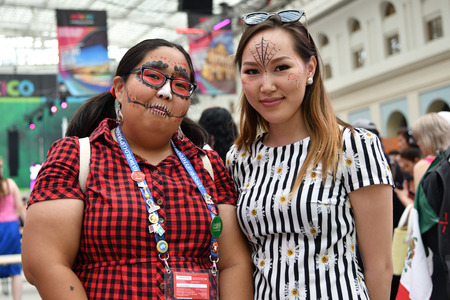 Moscow, Russia - June 29, 2018: Two chinese girls participants in sugar skull makeup during Dia de...