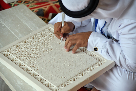 Hands of an arabian male gypsum carver close up. Qatarの写真素材