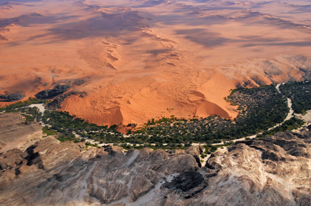 Aerial view on the beautiful landscape of the Kuiseb canyon in Namib desert at sunset. Flying on a small plane over the desert is one of the most popular tourist attractions in Namibiaの写真素材