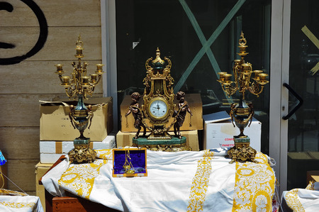 Pescara, Italy - July 2, 2006: Ancient bronze watches, candelabras, arts etc for sale at Pescara's street flea market. This flea market very popular between locals and touristsのeditorial素材