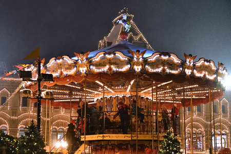 Moscow, Russia - January, 02, 2019: People have a fun on the vintage carousel on the Red Square as part of the Christmas holiday at snowfall eveningのeditorial素材