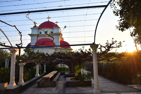 The Greek Orthodox Church of the Holy Apostles in Capernaum near the shore of the Sea of Galilee in Israel shown at sunsetの写真素材
