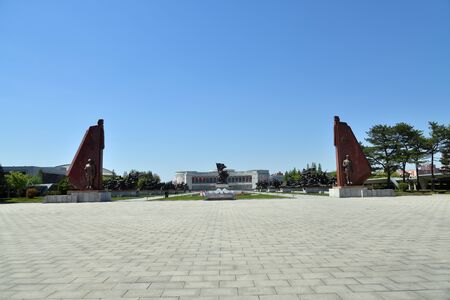 Pyongyang, North Korea - May 2, 2019: Square in front of Museum of Victory. Statue of a soldier with a flag at the entrance to the Victorious Fatherland Liberation War Museum. North Korea. DPRKのeditorial素材