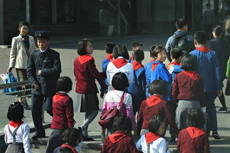 Pyongyang, North Korea - April 29, 2019: Young children, members of the Korean Children's Union KCU, Young Pioneer Corps, on a city streetのeditorial素材
