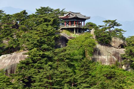 North Korea - May 4, 2019:  Mt. Kumgang biosphere reserve. Lagoon Samil. Inscription on the rock.  Pavilion in traditional style on top the cliffのeditorial素材