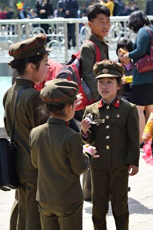 Pyongyang, North Korea - May 1, 2019: Groupof the  young girls dressed in uniform of the korean people army on the Pyongyang streetのeditorial素材
