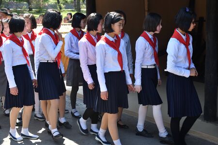 North Korea, Pyongyang - May 1, 2019: A group of North Korean children members of the Korean Childrens Union KCU, Young Pioneer Corps visit the Mangyongdae village, birthplace of Kim Il Sungのeditorial素材