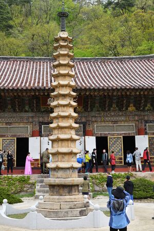 Myohan, North Korea - April 30, 2019: Tourists visit the Buddhist monastery Bohen. It was built in 1042 and is considered one of the best specimens representing the architecture of Koreaのeditorial素材