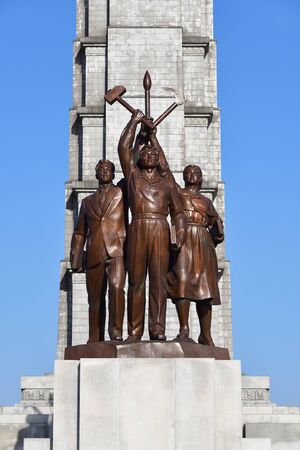 Pyongyang, North Korea - May 1, 2019: Tower of the Juche Idea and statue consisting of three idealised figures - worker, peasant and working intellectualのeditorial素材