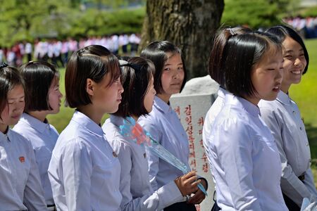 Pyongyang, North Korea - May 1, 2019: Young girls, members of the Kimilsungist-Kimjongilist Youth League visit the Mangyongdae village, birthplace of Kim Il Sungのeditorial素材