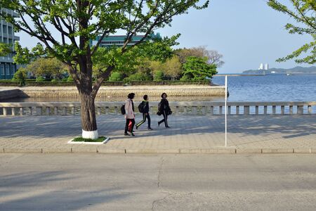 North Korea, Wonsan - May 3, 2019:  Children go on the promenade of the Japanese or Eastern Sea in Wonsanのeditorial素材