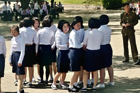 Pyongyang, North Korea - May 1, 2019: Young girls, members of the Kimilsungist-Kimjongilist Youth League on a city streetのeditorial素材