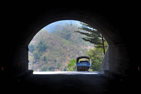North Korea - May 3, 2019: Roads of North Korea. A  road tunnel in the mountains and truck leaving itのeditorial素材