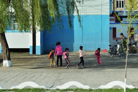 Wonsan, North Korea - May 4, 2019:  Street scene   in Wonsan, one of the North Korean port on the Eastern seashore. Children play on a streetのeditorial素材