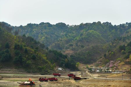 South Pyongan Province, North Korea - April 30, 2019: Gold mining on the river Taedong. Workers on the dredge washed gold dustのeditorial素材