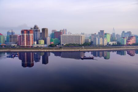 Pyongyang, North Korea -  April 30, 2019: Skyline and Taedong River in the morning fog. View on modern residential complex on the Othat Kangan street from the Yanggakdo islandのeditorial素材