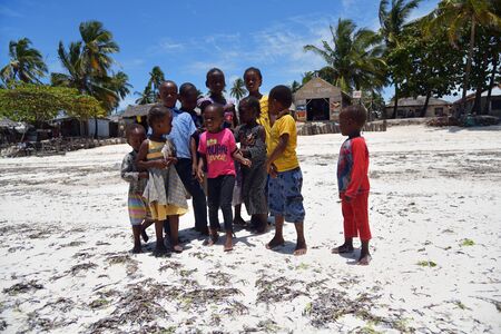 Pingwe, Zanzibar - October 6, 2019: Cheerful happy children on the Pingwe beach, local village on background. Tanzania, Africaのeditorial素材