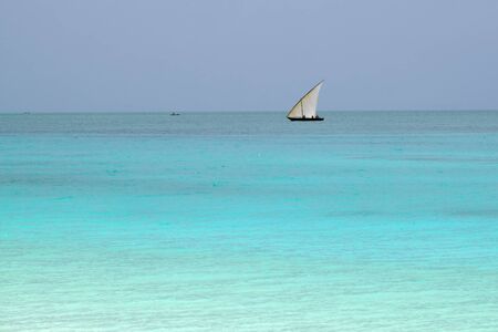 Dhow sailing boat in the Indian ocean at sunrise, Zanzibar, Tanzania, Africaの写真素材