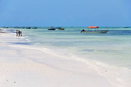 Pingwe, Zanzibar - October 6, 2019: Pingwe beach, fishing boats and local children on the shore. Tanzania, Africaのeditorial素材
