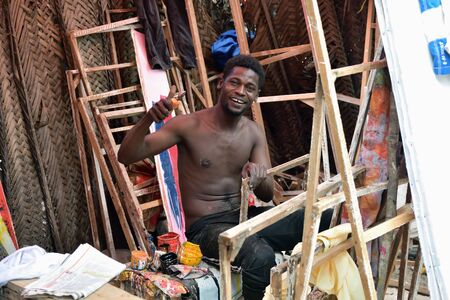 Kendwa, Zanzibar - October 4, 2019: Man, local artist in his workshop in Kendwa village. Tanzania, Africaのeditorial素材