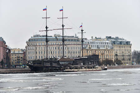 St Petersburg, Russia - January 30, 2020: Winter snowfall in the tourist center of the city. View on ice covered Neva river and floating restaurant Flying Dutchman as a sailing shipのeditorial素材