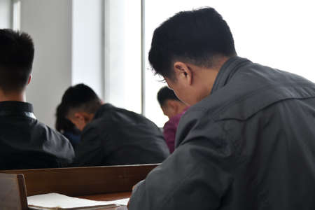 Pyongyang, North Korea - April 29, 2019: Students in the classroom of the Great People's Study House. Selective focusのeditorial素材