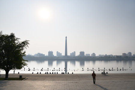 Pyongyang, North Korea - May 1, 2019: Locals fishermen catch a fish on waterfront on Kim Il Sung...