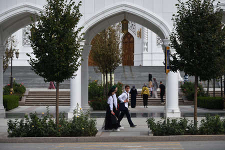 Shali, Chechnya Republic, Russia - September 10, 2021: Young people going dawn street against the Prophet Muhammad's Mosque called "Pride of the Muslims".のeditorial素材