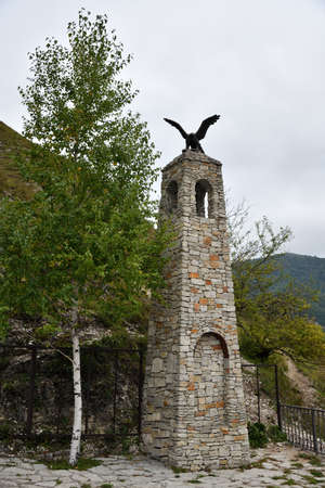 Chechnya, Russia - September 10, 2021: Replica of battle tower with bronze eagle on top. Zelimkhan Harachoevskiy monument, famous Chechen abrek, warrior from Caucasus mountainsのeditorial素材