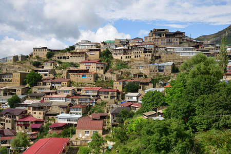 Picturesque Chokh town with old brick buildings on hill steep slope among fantastic mountains on sunny day. Dagestan, Russiaの写真素材