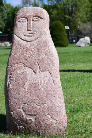 Cholpon-Ata, Kyrgyzstan - September 14, 2022: Turkic stone statue with replica of ancient petroglyphs. Ruh Ordo Cultural complex named after famous Kyrgyz writer Chinghiz Aitmatov, Issyk Kul lakeのeditorial素材