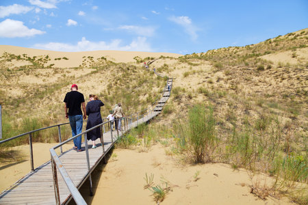 Dagestan, Russia - 20 July, 2022: Tourists visit the Sarykum dune. Dagestan, Russia. A unique sandy mountain in the Caucasusのeditorial素材