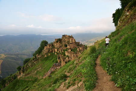 Dagestan, Russia - 23 July, 2022: Ancient village Gamsutl on rock. Amazing settlement of rock houses on top of mountain. Attraction of Dagestan - village of ghost in mountainsのeditorial素材