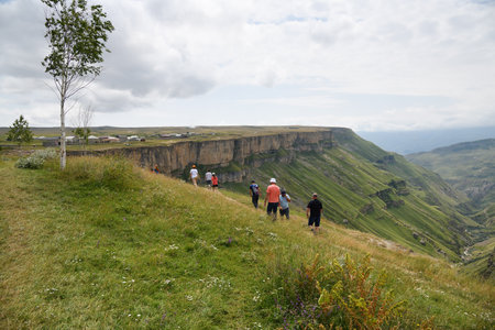 Dagestan, Russia - 21 July, 2022: People walk on the edge of the Khunzakh Canyon in the Republic of Dagestan, Russia. Stunning landscape of the Caucasus mountainsのeditorial素材